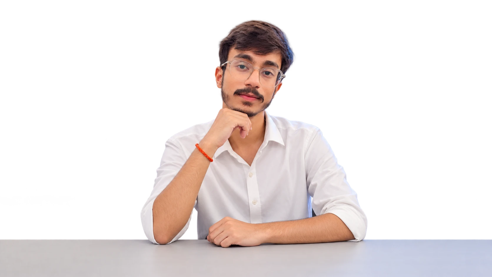 Aviral Singh, founder of PureFlow Studios, seated at a light-grey table